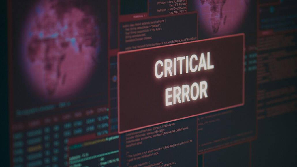 Computer showing hacking alert and critical error message flashing on screen